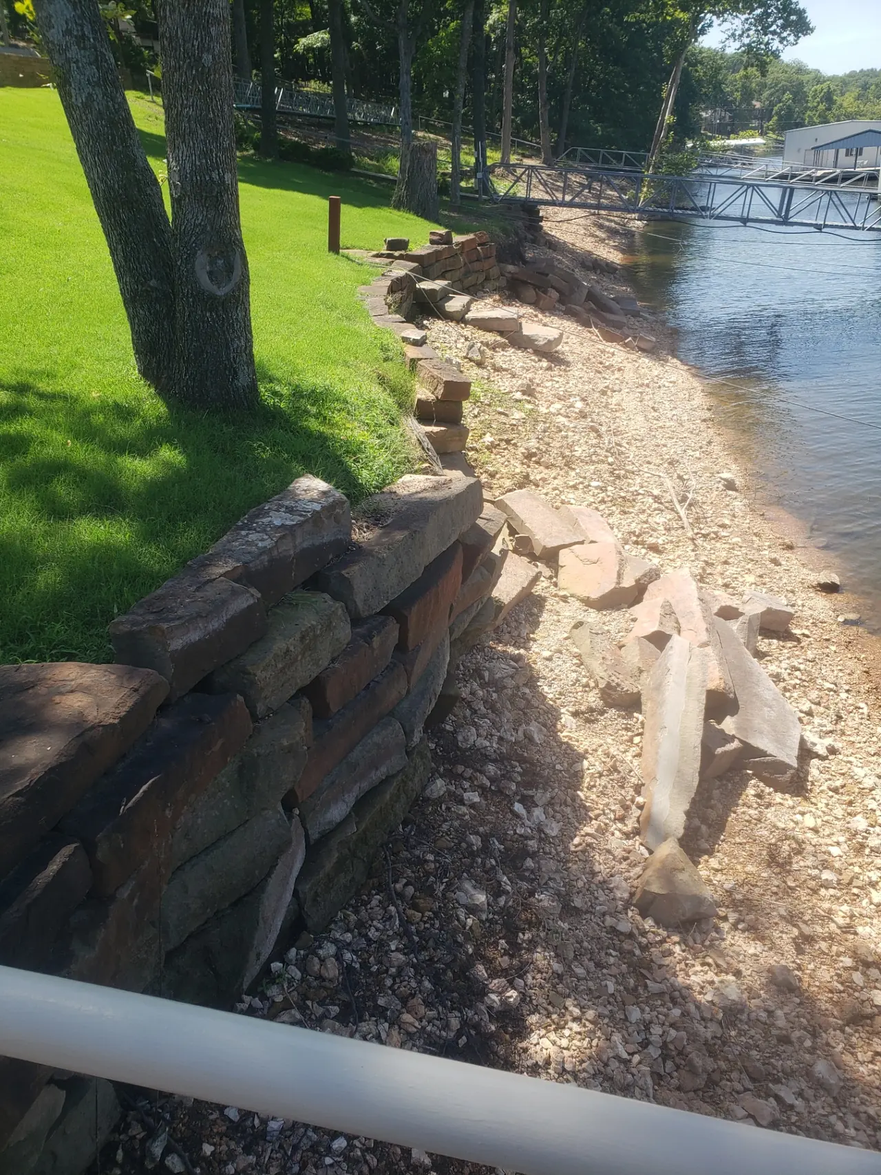 Grand Lake Seawall Rebuild — Engineered footing + new stone retaining wall
